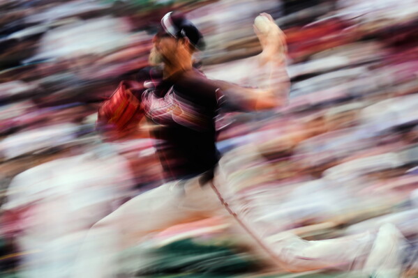 In this image taken with a slow shutter speed, Atlanta Braves' Chris Sale throws during the second inning of a baseball game against the Boston Red Sox, Thursday, May 28, 2026, in Boston. (AP Photo/Charles Krupa)