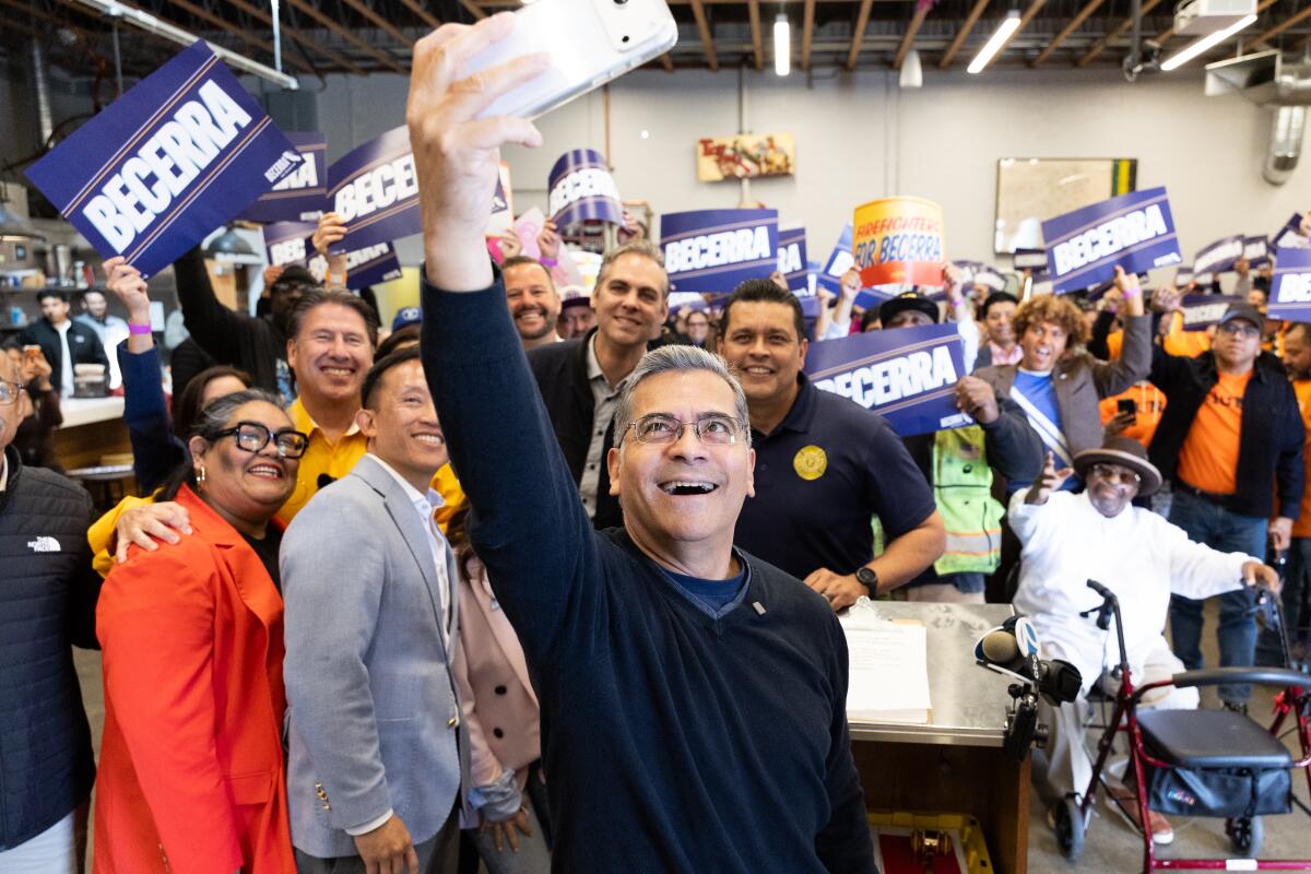 California gubernatorial candidate Xavier Becerra takes a selfie at an event while campaigning