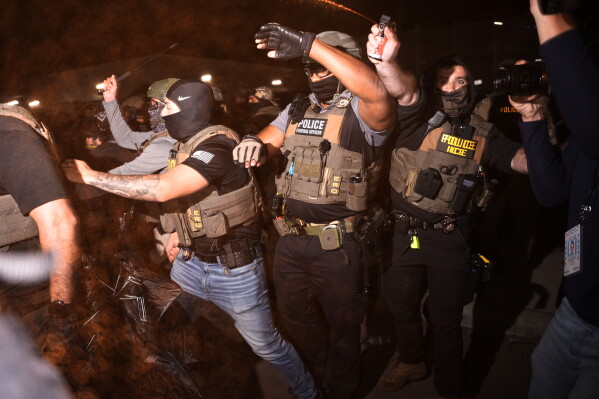 Federal immigration officers pepper spray protesters outside Delaney Hall detention center Thursday, May 28, 2026, in Newark, N.J. (AP Photo/Angelina Katsanis)