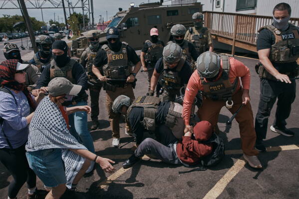 Protesters and ICE agents clash outside the Delaney Hall detention center after demonstrators stood by the entrance gates to protest the transfer of detainees on Tuesday, May 26, 2026, in Newark, N.J. (AP Photo/Andres Kudacki)