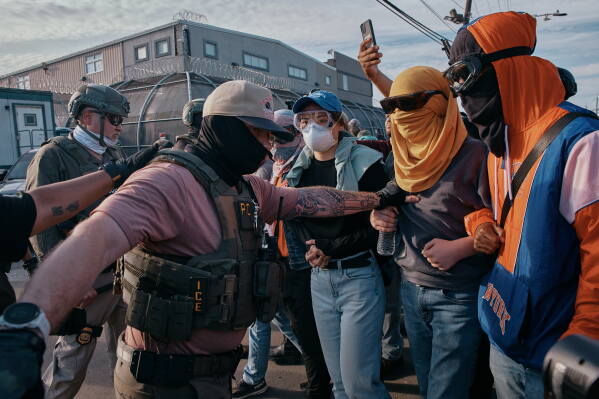 Protesters confront ICE agents outside the Delaney Hall detention center while demonstrating near the entrance gates, Wednesday, May 27, 2026, in Newark, N.J. (AP Photo/Andres Kudacki)