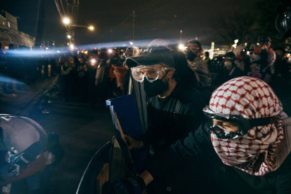 Protesters clash with ICE agents outside the Delaney Hall detention center while demonstrating near the entrance gates, Wednesday, May 27, 2026, in Newark, N.J. (AP Photo/Andres Kudacki)