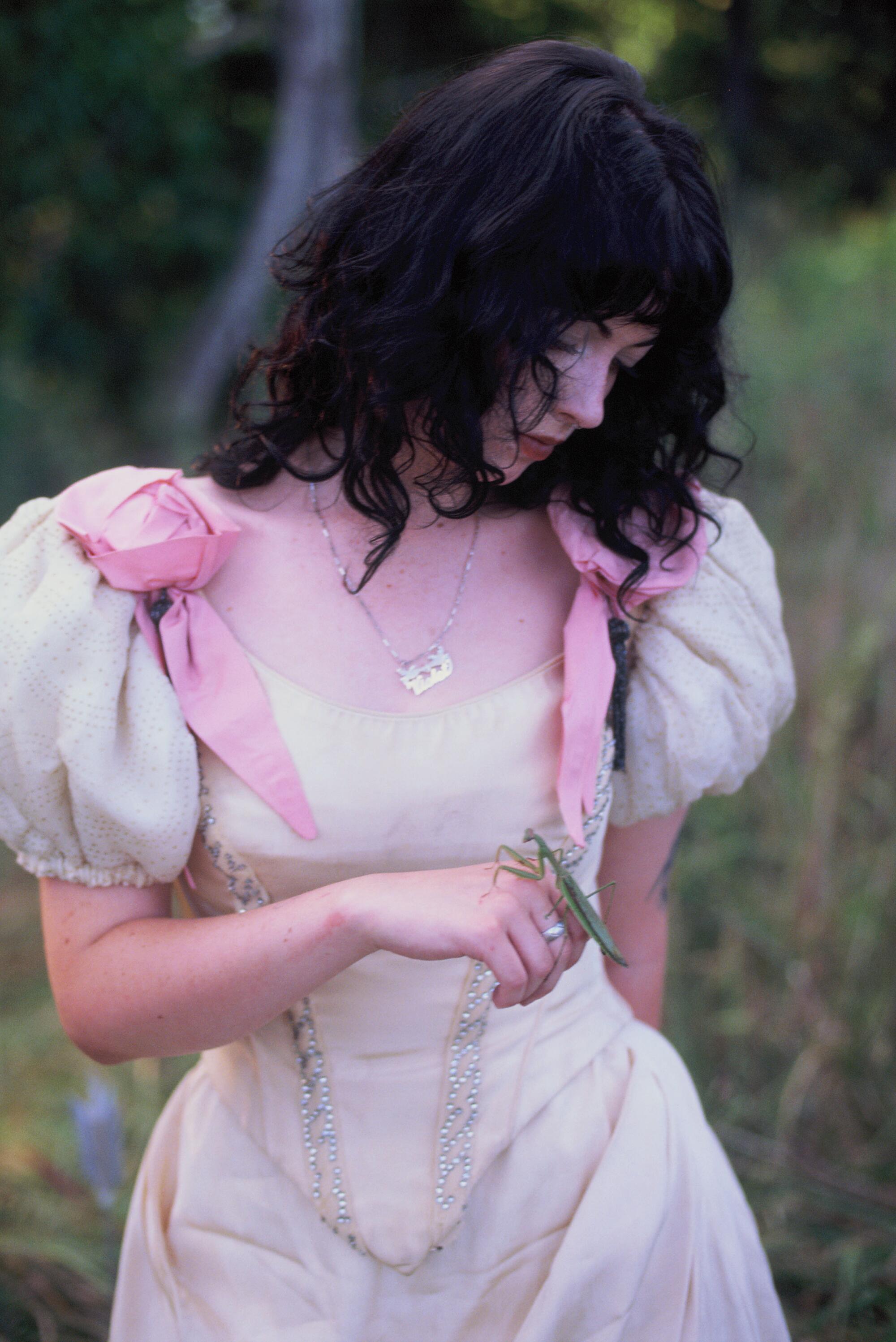 Young woman in a pink and white dress.