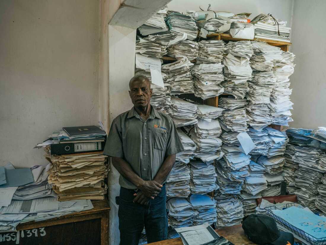 December 3, 2024. Death Registration Office, Kitwe, Zambia. Lazarus Kangasa waits at the Kitwe City Council Registration Office for a burial permit, the final step in certifying and obtaining his son’s death certificate. Photo Credit: Juan Arredondo.