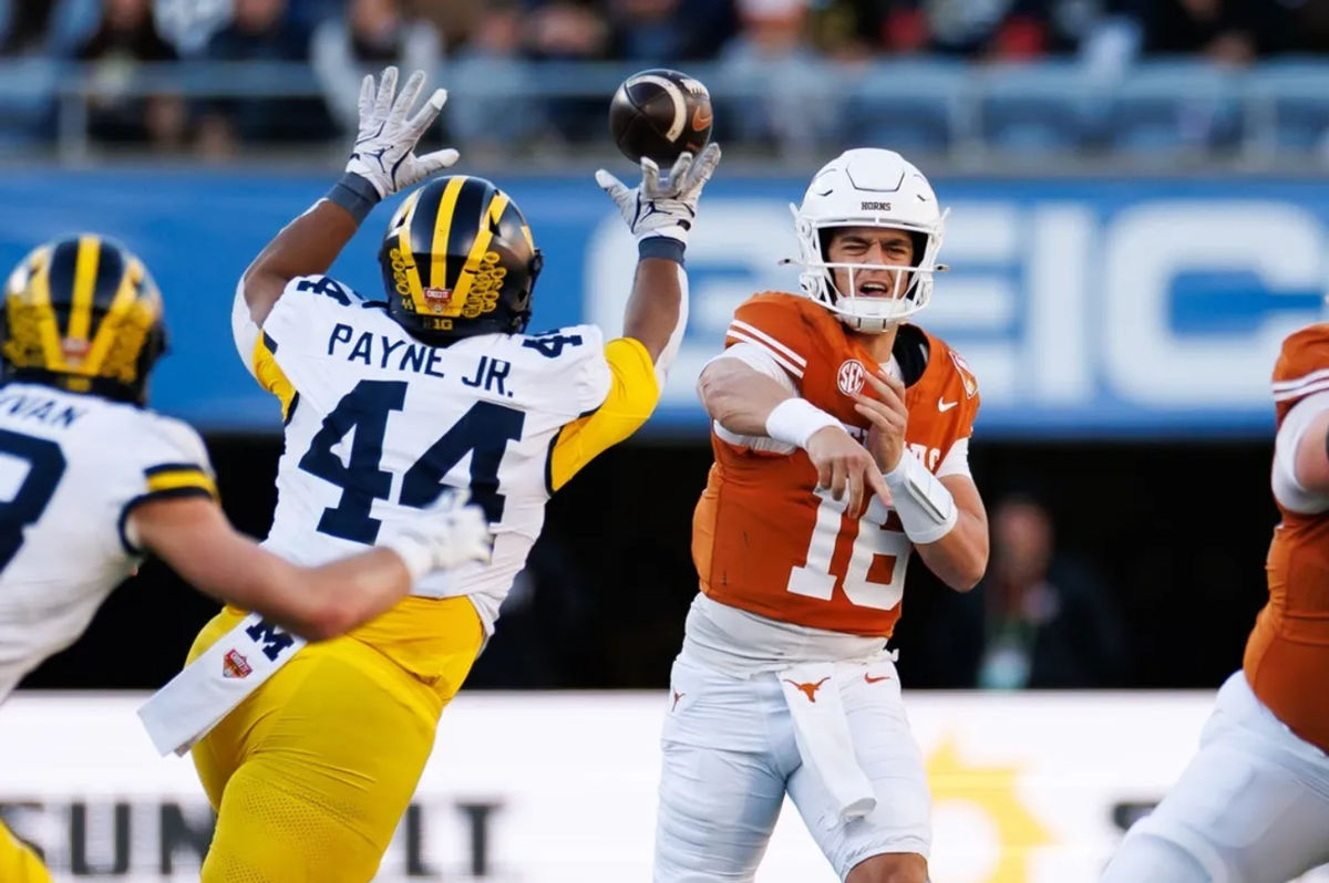 Dec 31, 2025; Orlando, FL, USA; Michigan Wolverines defensive lineman Damon Payne (44) tips a pass from Texas Longhorns quarterback Arch Manning (16) during the first half at Camping World Stadium. Mandatory Credit: Matt Pendleton-Imagn Images