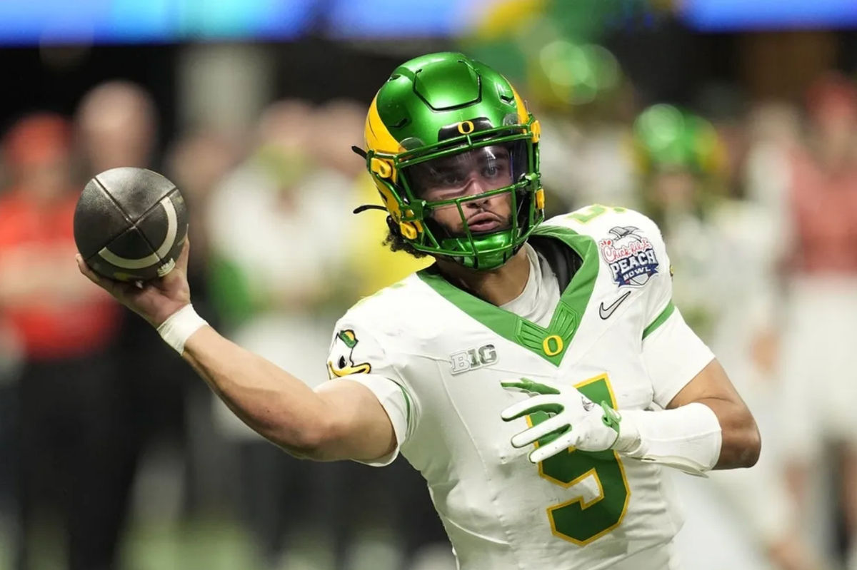 Jan 9, 2026; Atlanta, GA, USA; Oregon Ducks quarterback Dante Moore (5) throws a pass during the fourth quarter the 2025 Peach Bowl and semifinal game of the College Football Playoff at Mercedes-Benz Stadium. Mandatory Credit: Dale Zanine-Imagn Images