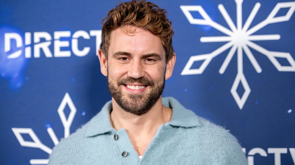 Nick Viall standing at a private residence during a Christmas event