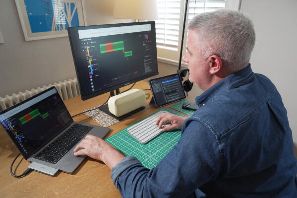 Musician Samuel Smith edits audio at his home, in London, Tuesday, May 12, 2026, (AP Photo/Mustakim Hasnath)