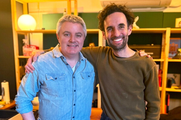 In this photo provided by Samuel Smith, the musician, left, poses for a photo with Julian Lage during a session recording for Smith's album, 'The Art of Letting Go', in 2025. (Samuel Smith via AP) CORRECTION: Spelling corrected to Lage, instead of Large