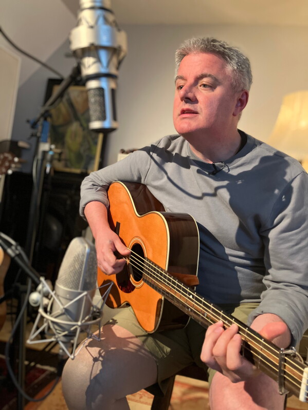 In this 2013 photo provided by Samuel Smith, the musician plays guitar in his home studio. (Samuel Smith via AP)