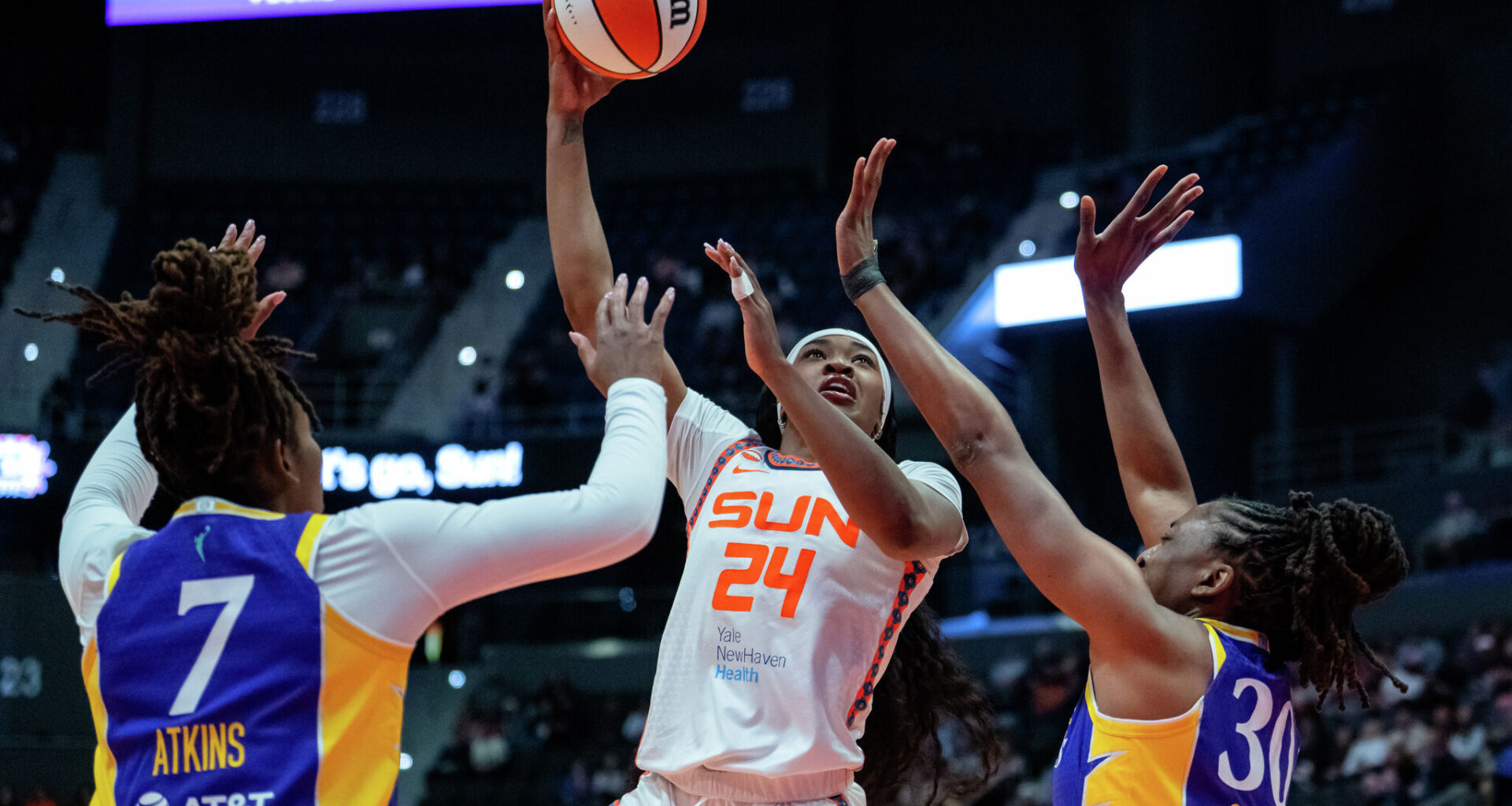 Aneesah Morrow (24) of the Connecticut Sun shoots against Ariel Atkins (7) and Nneka Ogwumike (30) of the Los Angeles Sparks during the first half of a WNBA basketball game at PeoplesBank Arena on May 30, 2026 in Hartford, Connecticut. 