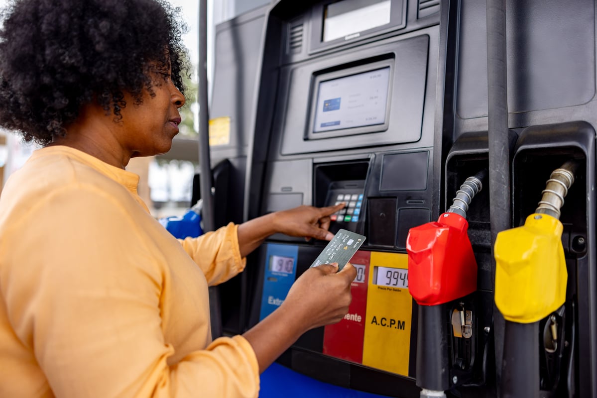 Person paying for gas with credit card at pump.