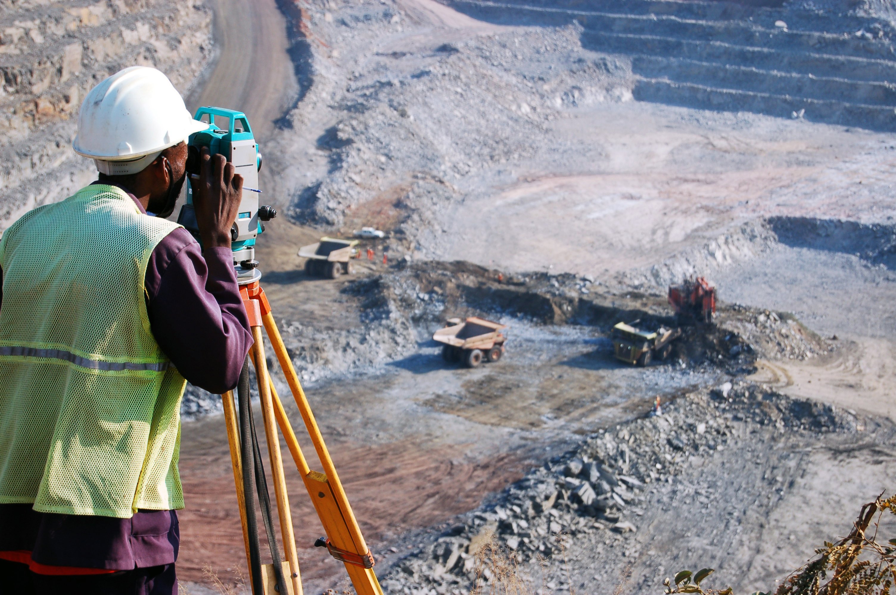 A surveyor looking out over an open mine.
