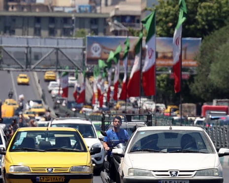 Iranians drive in a street in Tehran at the weeken