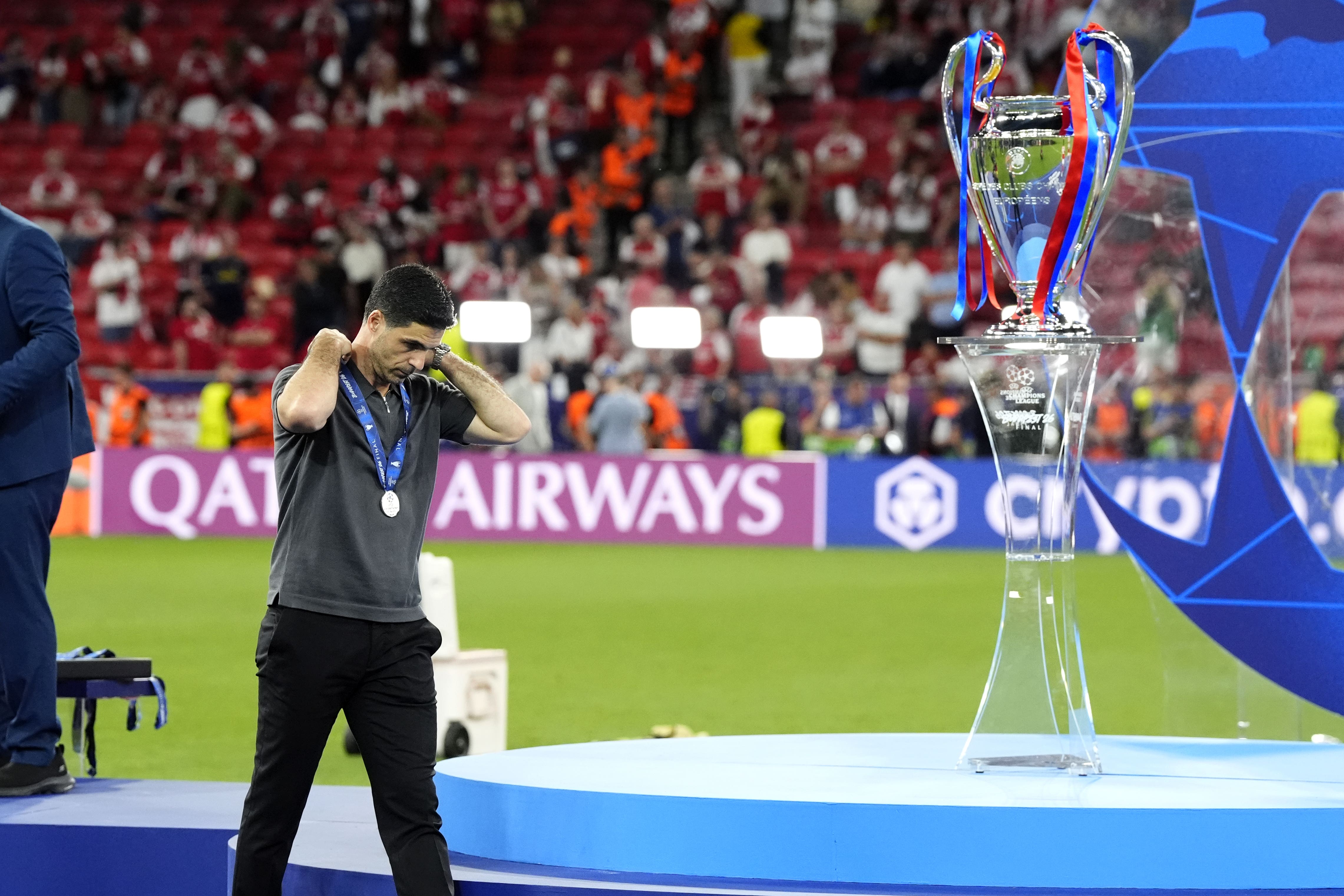 Arsenal manager Mikel Arteta walks past the trophy following defeat