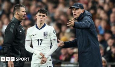 Thomas Tuchel gesticulates while standing next to Phil Foden