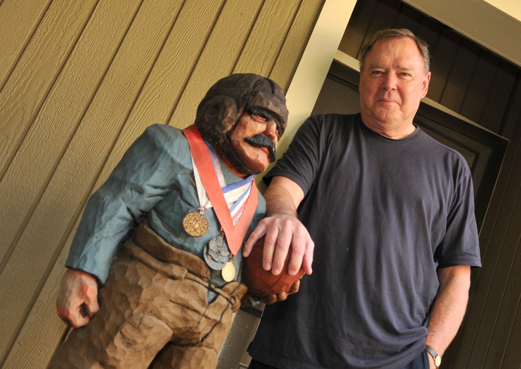 Former NFL quarterback Craig Morton with a wooden statue of a football player he calls "Butkus."