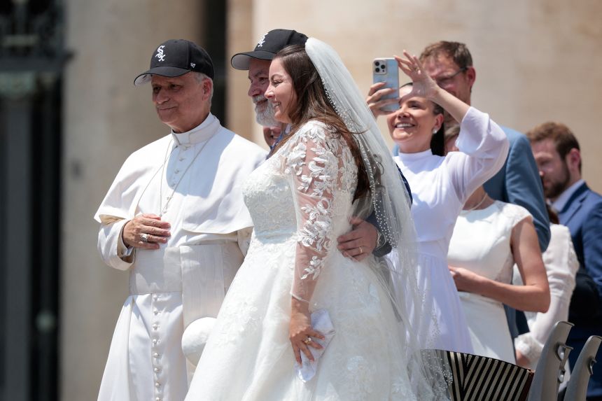 Pope Leo XIV wears a Chicago White Sox cap as he poses for a picture with people on the day of his general audience in St. Peter's Square, at the Vatican June 11, 2025.
