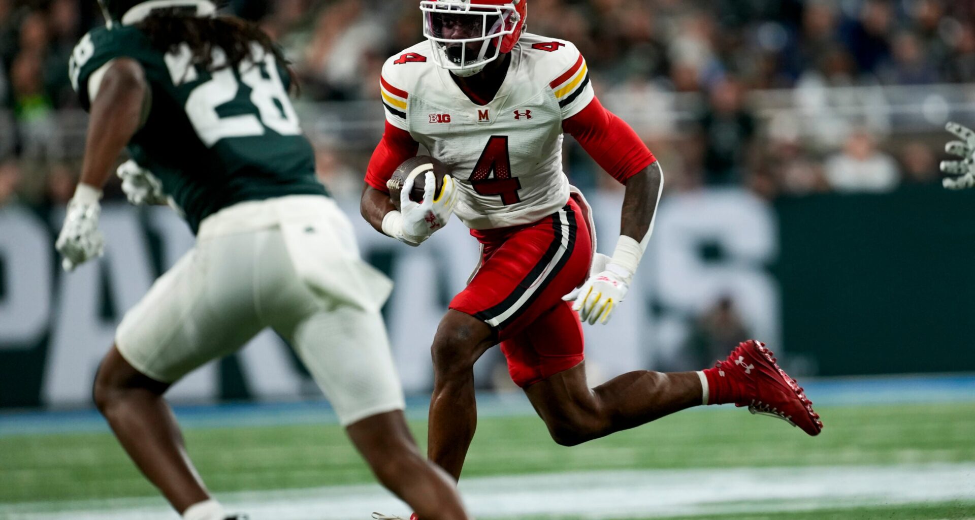 Nov 29, 2025; Detroit, Michigan, USA; Maryland wide receiver Shaleak Knotts (4) runs into Michigan State defensive back Dontavius Nash (28) in the second quarter at Ford Field.