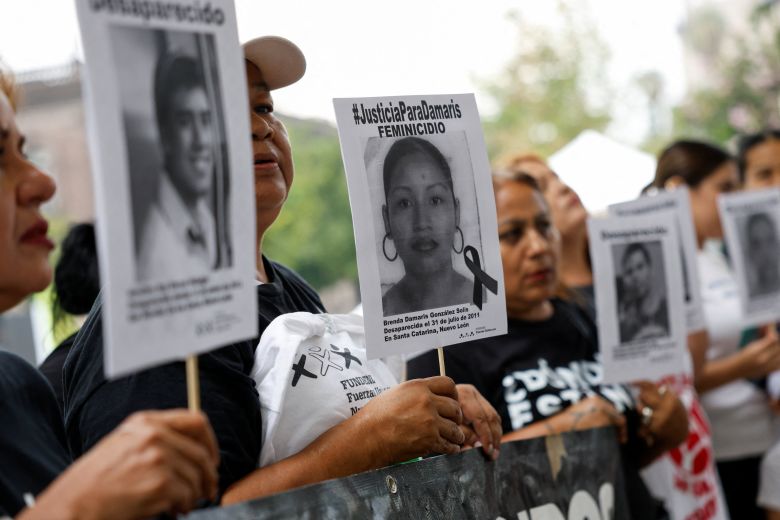 Members of the missing persons search collective United Forces for Our Disappeared in Nuevo Leon (FUNDENL), hold portraits of their missing relatives before a soccer match in memory of the missing ahead of the World Cup, in front of the Government Palace of Nuevo Leon, in Monterrey, Mexico, on May 17, 2026.