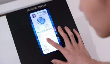 A person interacts with a Samsung Display screen showing health metrics and 'Heart Rate Sensing.'