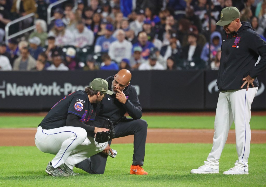 New York Mets pitcher Clay Holmes (35) has a trainer look at him during the fourth inning when the New York Mets played the New York Yankees Friday, May 15, 2026 at Citi Field in Queens, NY.