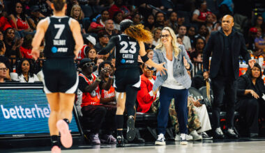Aces head coach Becky Hammon high-fives Aces guard Chennedy Carter (23) as she heads back to th ...