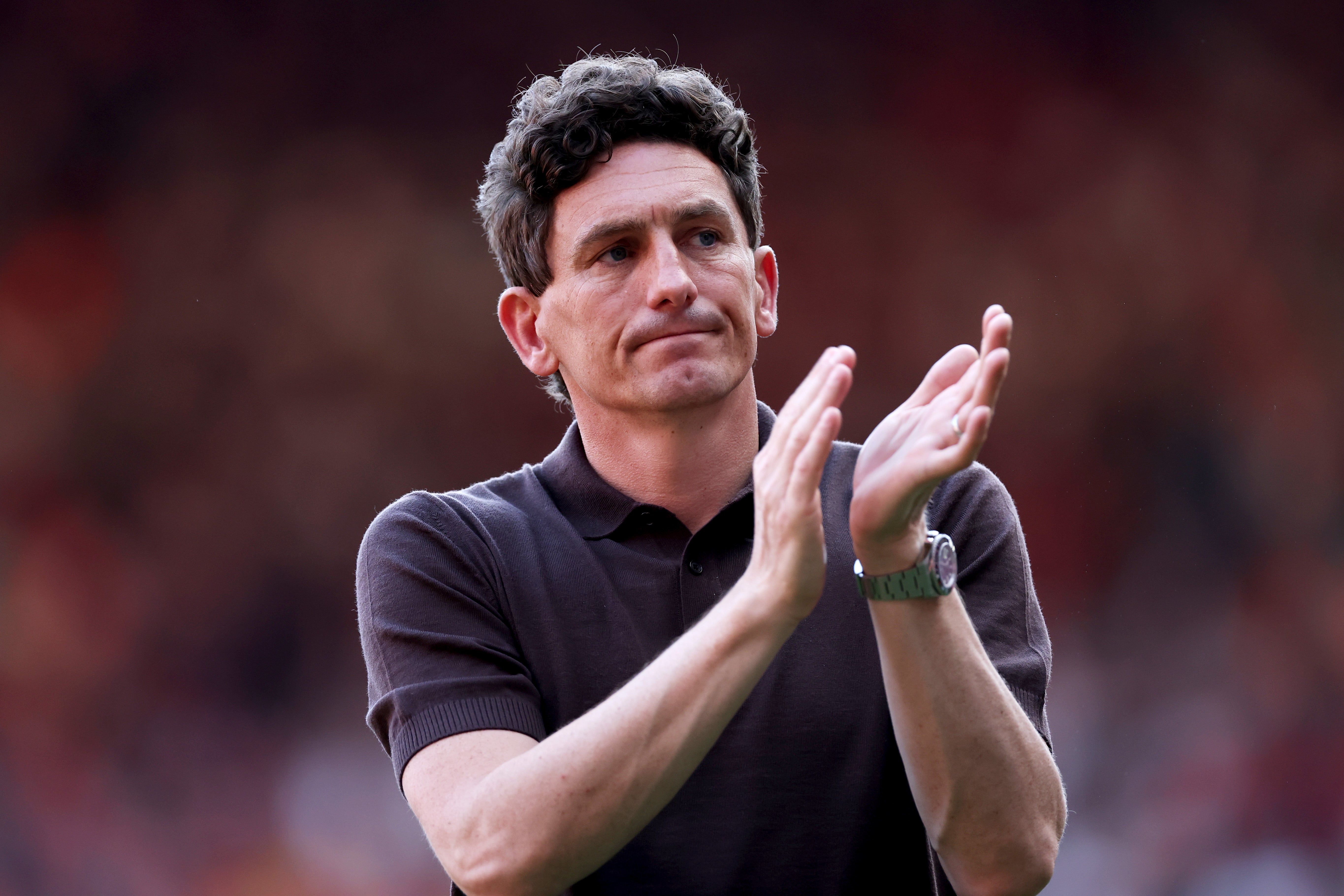 Keith Andrews, Manager of Brentford, applauds the fans after keeping the Bees in the Premier League