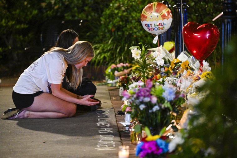 Students hold a vigil near the scene of a shooting at Florida State University
