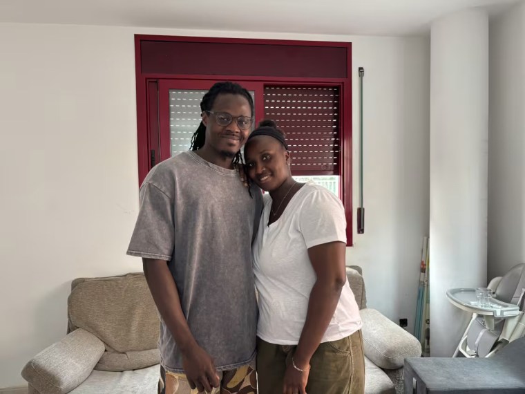 Diadji Nguirane and his partner, Maimouna Gueye, in the living room of their home in the town of Terrassa, about 17 miles from Barcelona.