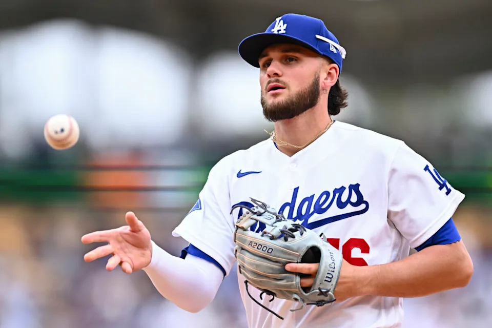 Apr 12, 2026; Los Angeles, California, USA; Los Angeles Dodgers second baseman Alex Freeland (76) tosses the ball to first base to force an out against the Texas Rangers during the fifth inning at Dodger Stadium. Mandatory Credit: Jonathan Hui-Imagn Images