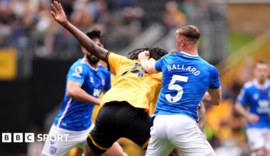 Referee Paul Tierney speaks with Lisandro Martinez of Manchester United after showing him a red card for pulling the hair of Dominic Calvert-Lewin of Leeds United