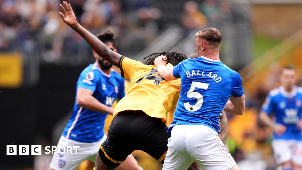Referee Paul Tierney speaks with Lisandro Martinez of Manchester United after showing him a red card for pulling the hair of Dominic Calvert-Lewin of Leeds United