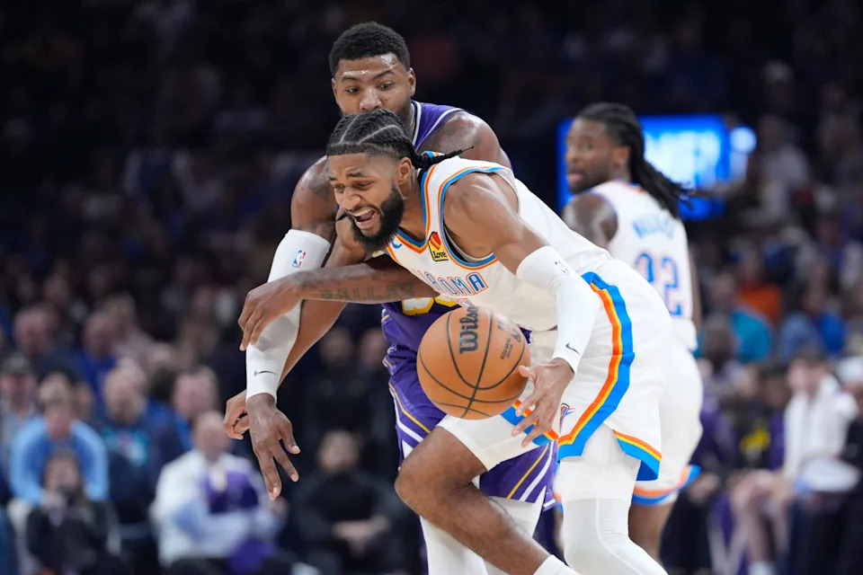 Oklahoma City Thunder guard Isaiah Joe (11) is fouled by Los Angeles Lakers guard Marcus Smart (36) during an NBA basketball game between the Oklahoma City Thunder and the Los Angeles Lakers at Paycom Center in Oklahoma City, Wednesday, Nov. 12, 2025.