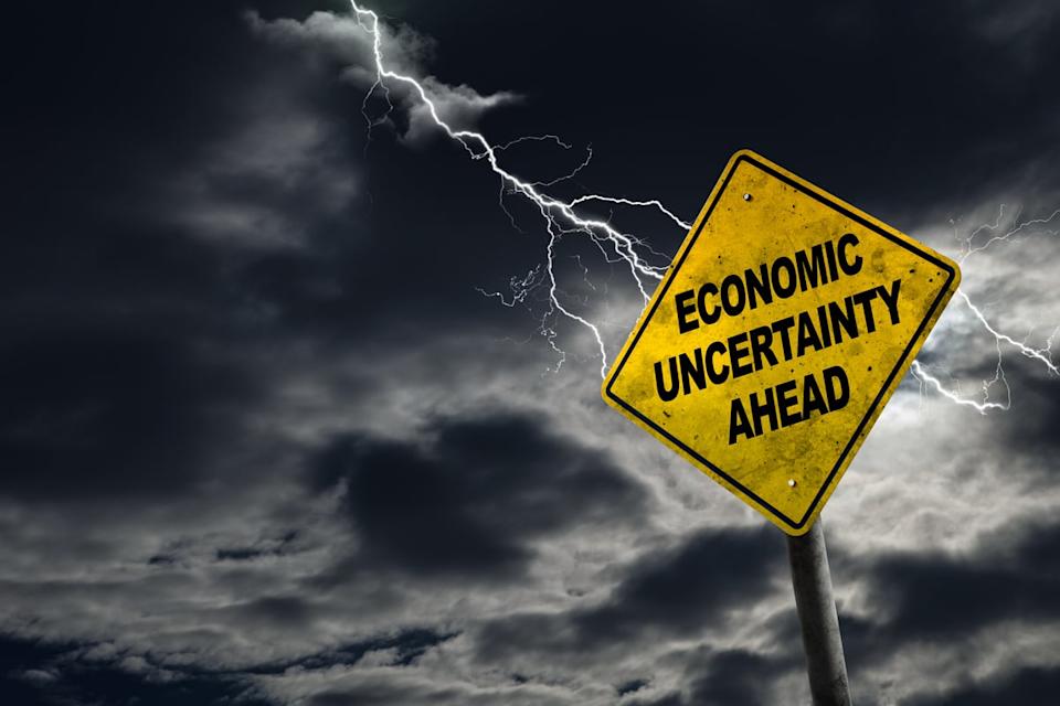 A road sign that reads Economic Uncertainty Ahead with lightning in the background.