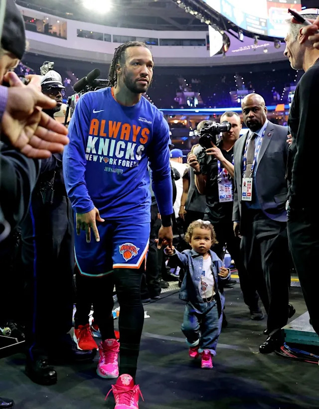 Knicks guard Jalen Brunson #11 and his daughter as they walk off the court <br>after Game 4. Charles Wenzelberg / New York Post