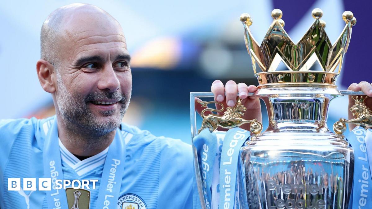 A smiling Pep Guardiola alongside the Premier League trophy in a previous season