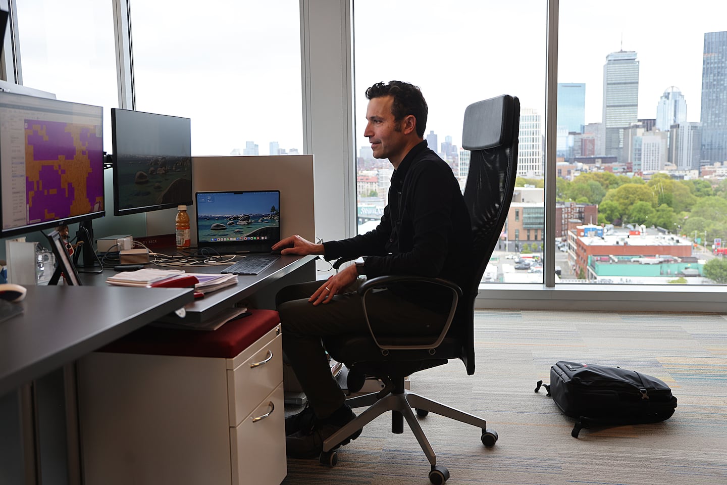 Andy Beck, Chief Executive Officer and Co-founder of PathAI, works at his desk in his office overlooking Boston.