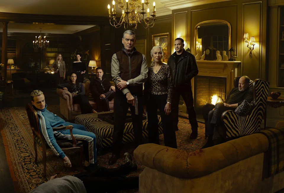 Anson Boon as Eddie Harrigan and cast members seated in a living room scene from Mobland season 1