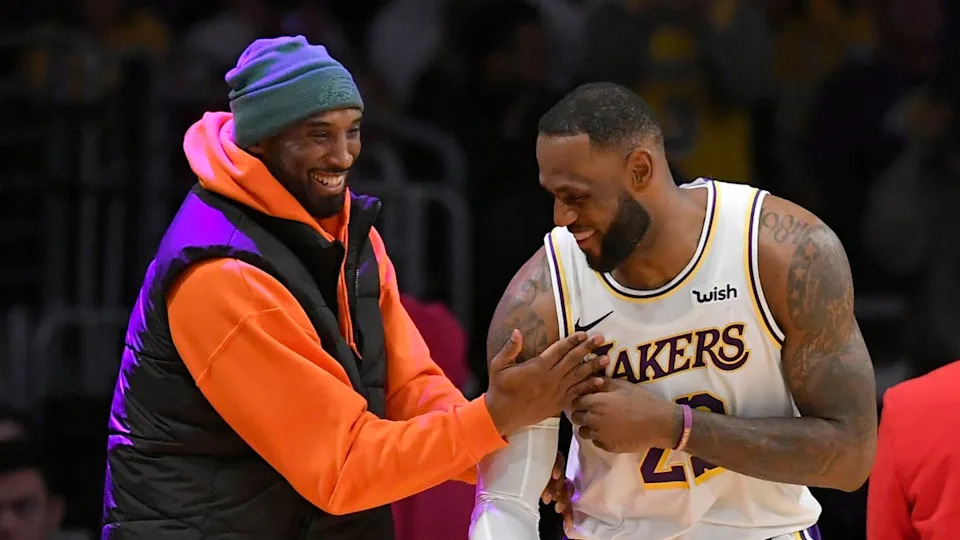 LOS ANGELES, CA - DECEMBER 29: LeBron James #23 of the Los Angeles Lakers has a moment on the sideline with former Laker Kobe Bryant in the second half during a game against the <a class="link " href="https://sports.yahoo.com/nba/teams/dallas/" data-i13n="sec:content-canvas;subsec:anchor_text;elm:context_link" data-ylk="slk:Dallas Mavericks;sec:content-canvas;subsec:anchor_text;elm:context_link;itc:0" data-yga="{"yLinkElement":"context_link","yModuleName":"content-canvas","yLinkText":"Dallas Mavericks","ySubModuleName":"anchor_text","yHasCommerce":false}">Dallas Mavericks</a> at Staples Center on December 29, 2019 in Los Angeles, California. (Photo by John McCoy/Getty Images)