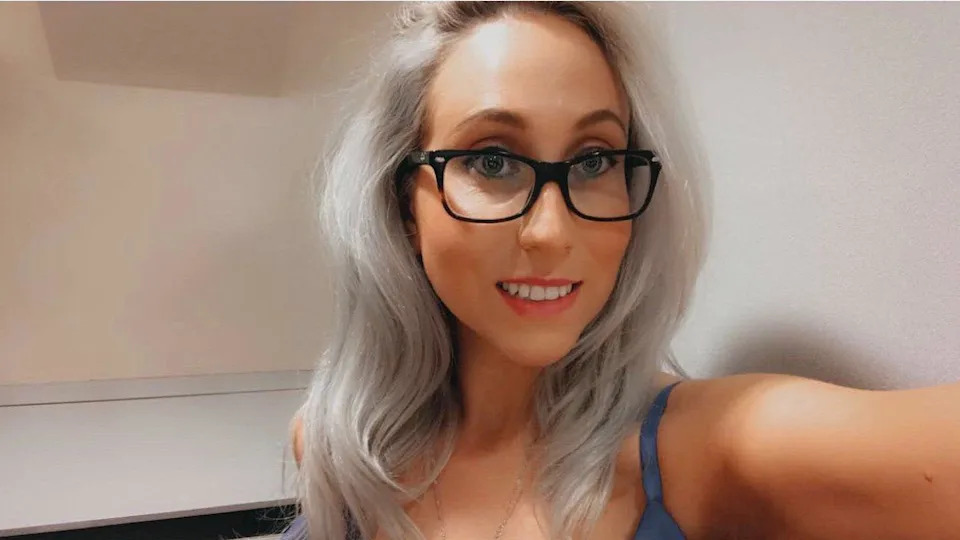 A young woman with light blonde hair taking a selfie