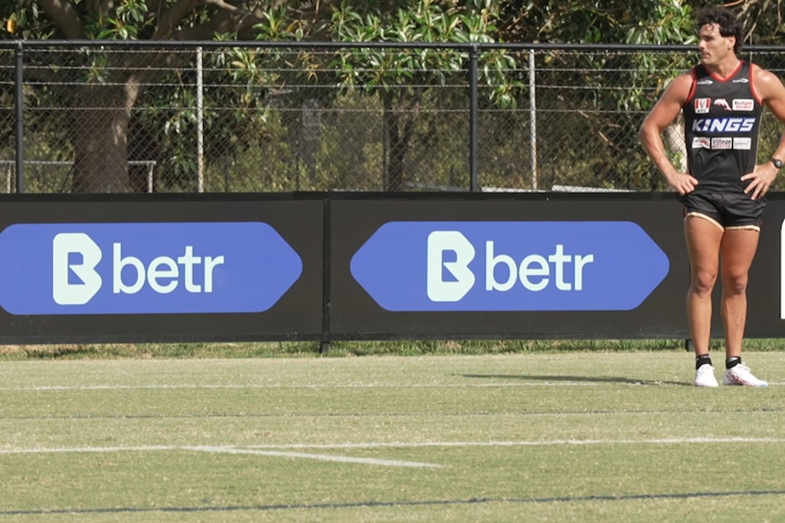 Fences surrounding a footy field feature logos for Betr.
