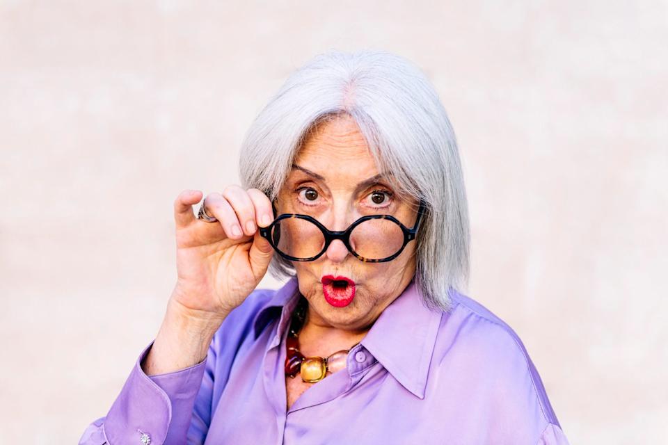 Someone is taking off her glasses and looking very surprised.