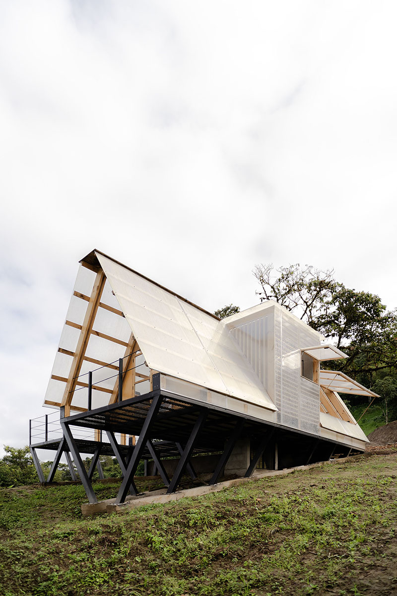 translucent polycarbonate skin envelopes triangular shelter elevated on stilts in ecuador - 2