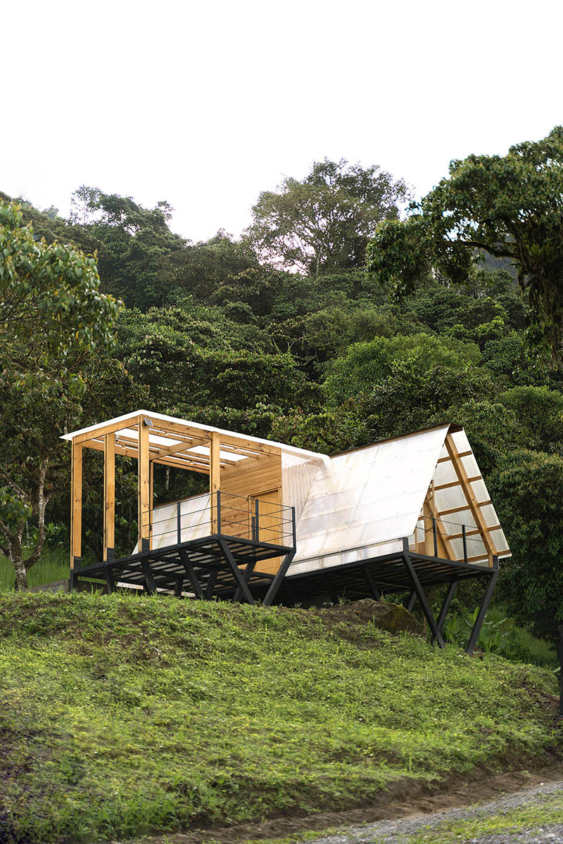 translucent polycarbonate skin envelopes triangular shelter elevated on stilts in ecuador - 1