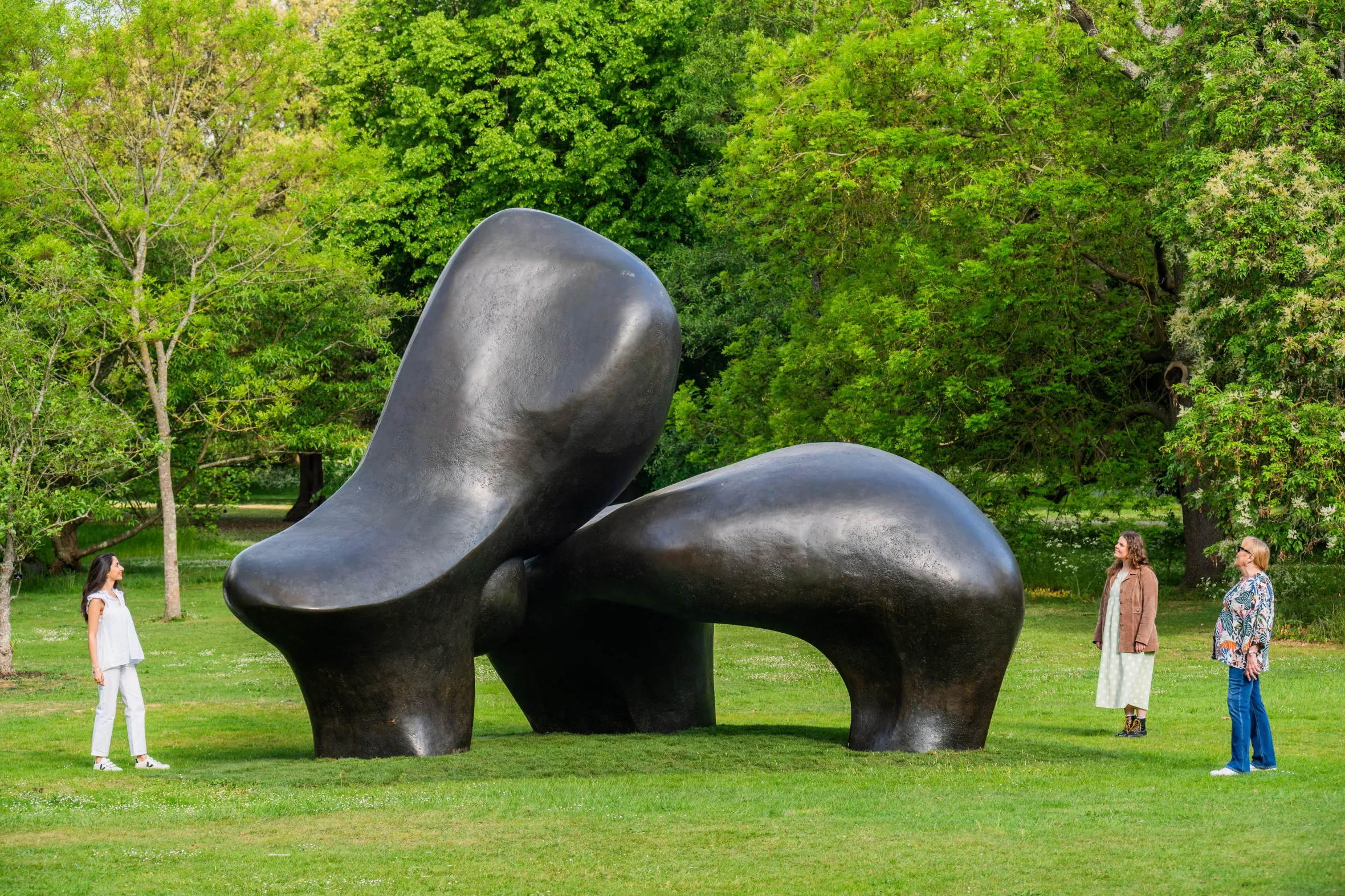 Sheep Piece - Henry Moore sculpture at Kew Gardens with three women observing.