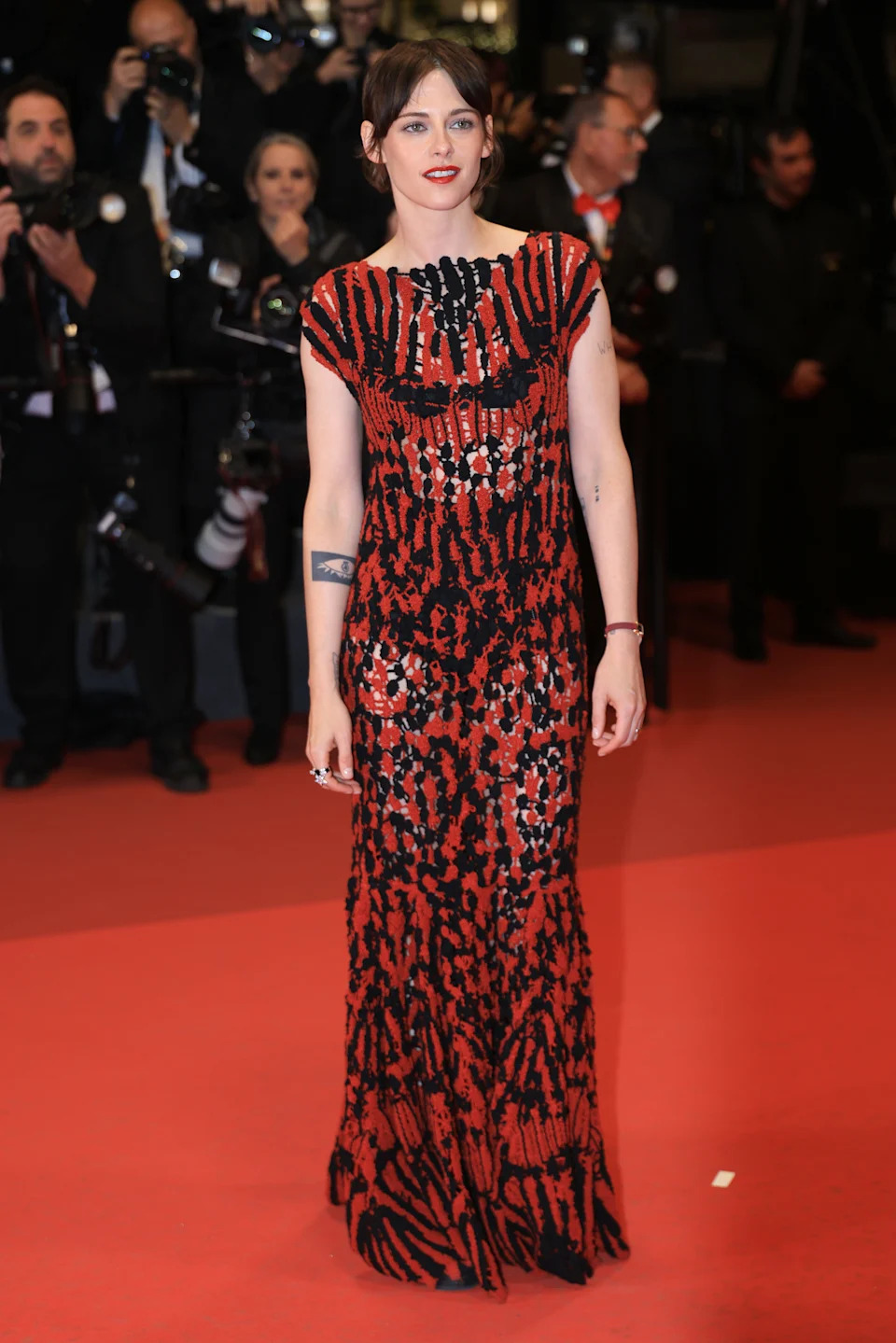 Kristen Stewart on a red carpet in front of photographers.