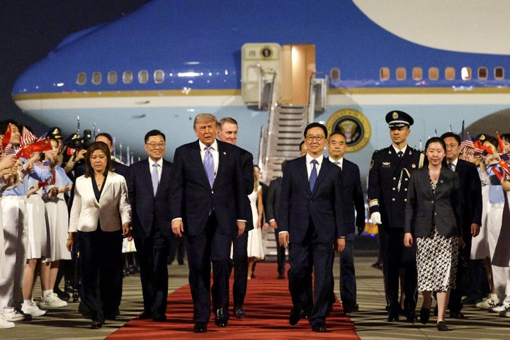 President Donald Trump (C) is joined by Chinese Executive Vice Minister of Foreign Affairs Ma Zhaoxu, U.S. Ambassador to China David Perdue, Vice President of China Han Zheng and Chinese Ambassador to the U.S. Xie Feng as he arrives at Beijing Capital International Airport on May 13, 2026 in Beijing, China. (Photo by Alex Wong/Getty Images)