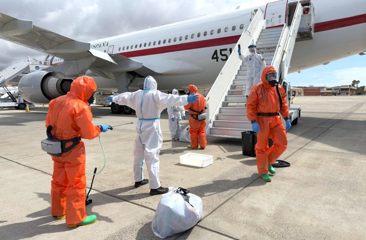 A former passenger from the hantavirus-stricken cruise ship MV Hondius is sprayed with disinfectant by Spanish government officials after disembarking in the Canary Islands, Spain, on Sunday.