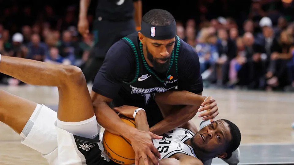 Minnesota Timberwolves guard <a class="link " href="https://sports.yahoo.com/nba/players/4246/" data-i13n="sec:content-canvas;subsec:anchor_text;elm:context_link" data-ylk="slk:Mike Conley;sec:content-canvas;subsec:anchor_text;elm:context_link;itc:0" data-yga="{"yLinkElement":"context_link","yModuleName":"content-canvas","yLinkText":"Mike Conley","ySubModuleName":"anchor_text","yHasCommerce":false}">Mike Conley</a> competes for the ball with San Antonio Spurs guard De'Aaron FoxBruce Kluckhohn-Imagn Images